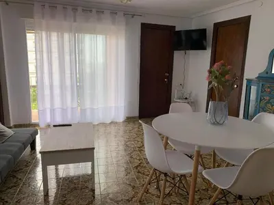 a living room with a white table and chairs at Sagunto 2 in Sagunto