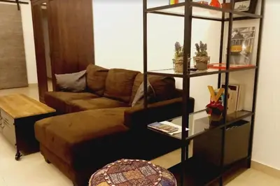 a living room with a couch and a book shelf at Loft Botanic Center in Valencia