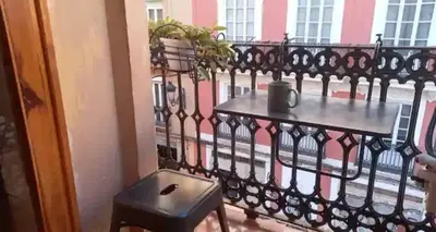 a balcony with a table and plants on a fence at Loft Botanic Center in Valencia