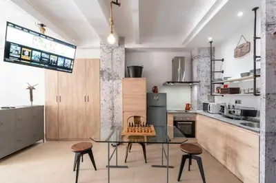 a kitchen with a glass table and some chairs at Loft Botanic Center in Valencia
