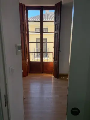 a hallway with a door with a view of a building at Tossal in Valencia
