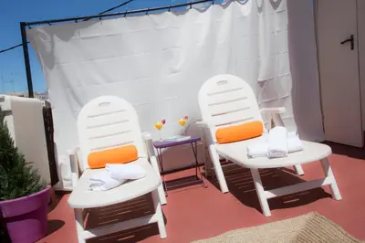 two white chairs sitting on top of a patio at Tossal in Valencia