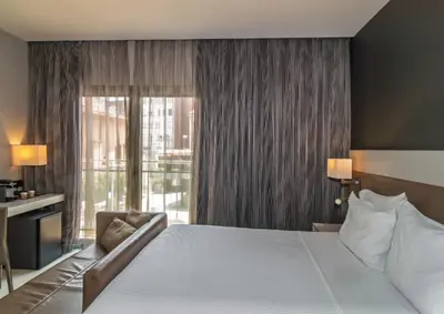 a bedroom with a large bed and a large window at SH Colón Valencia in Valencia