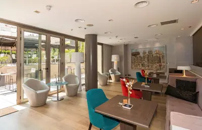 a living room with a couch and a table and chairs at SH Colón Valencia in Valencia