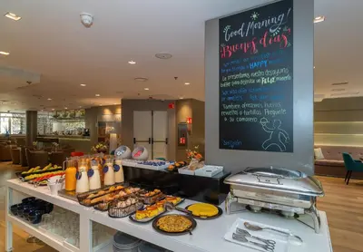 a buffet of food on a table in a restaurant at SH Colón Valencia in Valencia