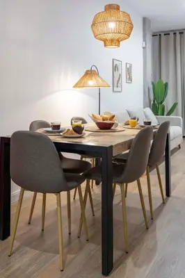 a dining room with a table with chairs and a couch at Travel Habitat Mediterranean Suites in Valencia