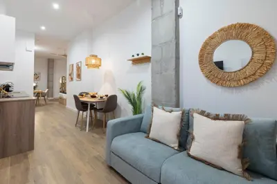 a living room with a blue couch and a table at Travel Habitat Mediterranean Suites in Valencia