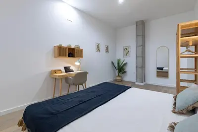 a bedroom with a bed and a desk and a bed at Travel Habitat Mediterranean Suites in Valencia