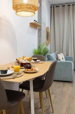 a dining room table with a plate of food on it at Travel Habitat Mediterranean Suites in Valencia