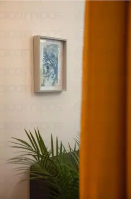 a picture hanging on a wall next to a plant at RA - Stylish city loft - Walk to the best of Valencia in Valencia
