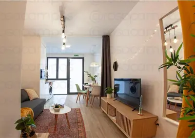 a living room with a couch and a tv at RA - Stylish city loft - Walk to the best of Valencia in Valencia