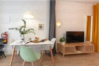 a living room with a table and a television at RA - Stylish city loft - Walk to the best of Valencia in Valencia