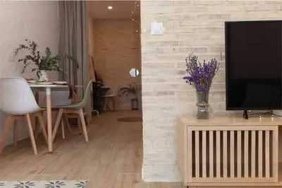 a living room with a television on a wooden stand at RB - Urban loft retreat, comfort & good location in Valencia