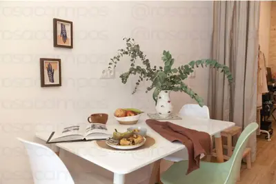 a white table with a plate of fruit and a book at RB - Urban loft retreat, comfort & good location in Valencia