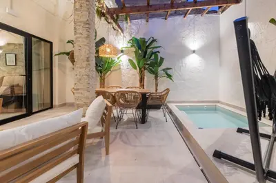 a living room with a table and a swimming pool at Apartamento con piscina y terraza in Valencia