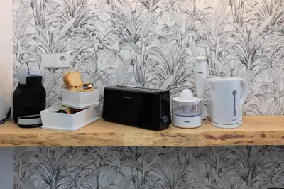 a shelf with a microwave and other items on it at Apartamento con piscina y terraza in Valencia