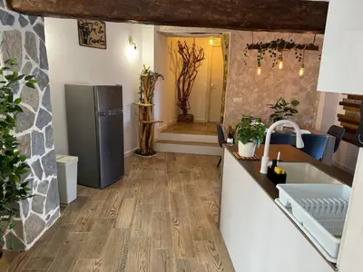 a kitchen with wooden floors and a refrigerator at La Casucha de Chulilla in Chulilla