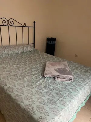 a bed with a blanket and a towel on it at Wohnung in Chilches in Xilxes