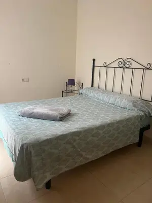a bed with a pillow on it in a bedroom at Wohnung in Chilches in Xilxes
