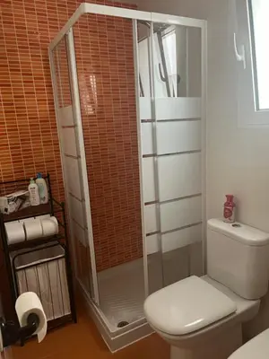 a bathroom with a toilet and a glass shower at Wohnung in Chilches in Xilxes