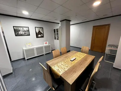 a conference room with a wooden table and chairs at RMN TOURIST HOME in Valencia