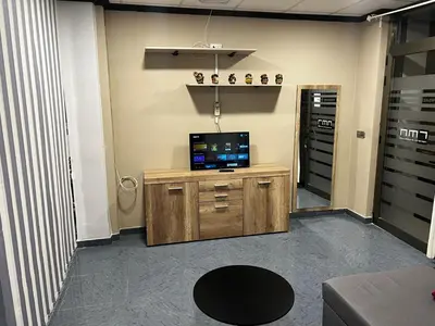 a living room with a television on a wooden cabinet at RMN TOURIST HOME in Valencia