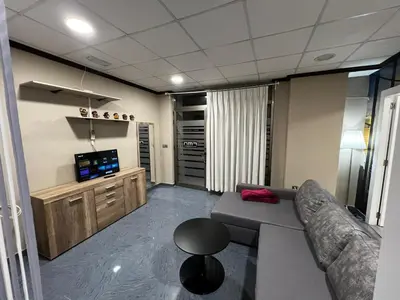 a living room with a couch and a television at RMN TOURIST HOME in Valencia