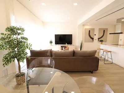 a living room with a couch and a glass table at Impresionante Apartamento 3 habitaciones by Hometels in Puerto de Sagunto