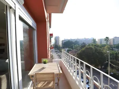 a balcony with a wooden table and a view of a city at Impresionante Apartamento 3 habitaciones by Hometels in Puerto de Sagunto