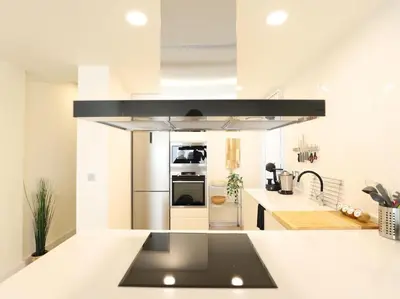 a kitchen with a sink and a stove top oven at Impresionante Apartamento 3 habitaciones by Hometels in Puerto de Sagunto