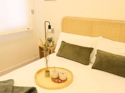 a bed with a tray with candles on it at Impresionante Apartamento 3 habitaciones by Hometels in Puerto de Sagunto