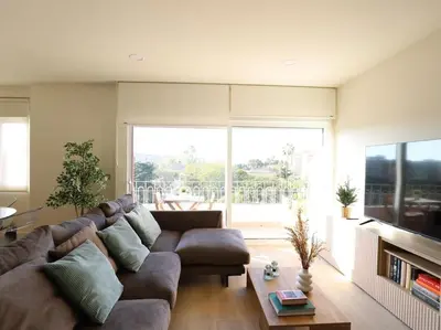 a living room with a large couch and a large window at Impresionante Apartamento 3 habitaciones by Hometels in Puerto de Sagunto