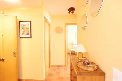 a room with a table with a lamp on it at Ático con piscina en excelente urbanización by Hometels in Canet de Berenguer