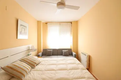 a bedroom with a bed and a window at Ático con piscina en excelente urbanización by Hometels in Canet de Berenguer
