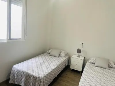 a bedroom with two beds and a window at Maison Sereine in Valencia