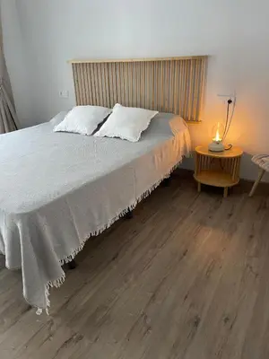a bedroom with a bed and a table with a lamp at Maison Sereine in Valencia