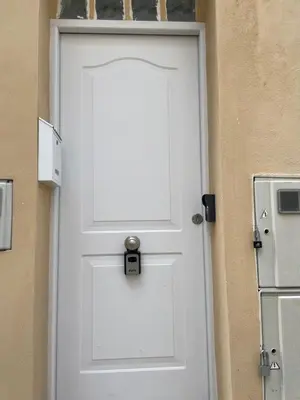 a white door with a window on a building at Maison Sereine in Valencia