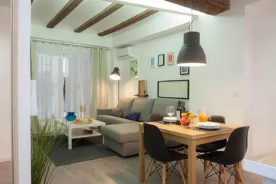 a living room with a table and a couch at SingularStays Mercado Central in Valencia