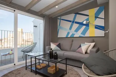 a living room with a couch and a glass table at SingularStays Mercado Central in Valencia