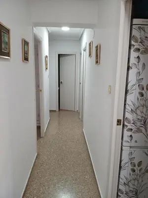a hallway with white walls and a mirror at Apartamento tradicional in Canet de Berenguer