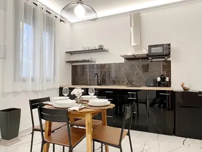 a kitchen with a table and chairs in a kitchen at Apartamento en la Gran Manzana in Valencia