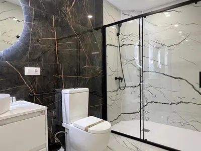 a bathroom with a toilet and a glass shower at Apartamento en la Gran Manzana in Valencia