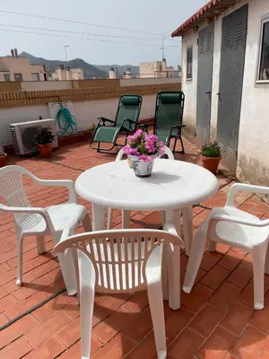 a white table and chairs on a patio at Apartamento Diagonal in Nules