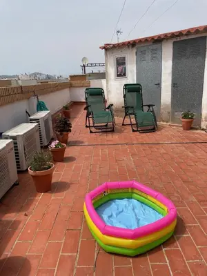 a hot tub sitting on a brick patio with chairs at Apartamento Diagonal in Nules