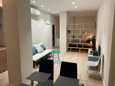 a living room with a couch and a table at Apartamento moderno de 70 metros a 300 metros de la playa in Valencia