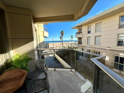 a balcony with a table and chairs and a view of the beach at Reinapart Patacona Beach 40 in Valencia