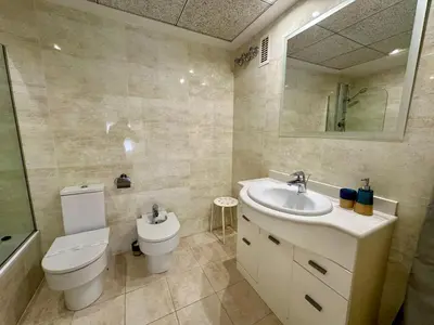 a bathroom with a toilet and a sink and a mirror at Reinapart Patacona Beach 40 in Valencia