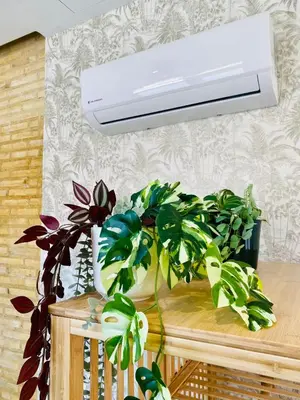 a room with a heater and plants on a table at FLORIT FLATS - The Cabanyal & Port Suites in Valencia