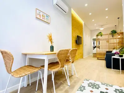 a dining room with a white table and chairs at FLORIT FLATS - The Cabanyal & Port Suites in Valencia