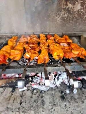 a bunch of food is cooking on a grill at Buen Estar, piscina, barbacoa, jacuzzi en Valencia in Turís